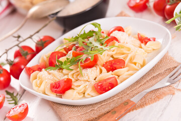 Orecchiette pasta with arugula and tomato.