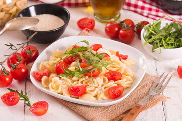 Orecchiette pasta with arugula and tomato.