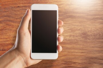Human hand hold a smartphone with blank screen
