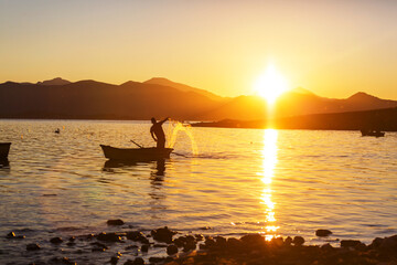 Fototapeta na wymiar Fisherman on sunrise