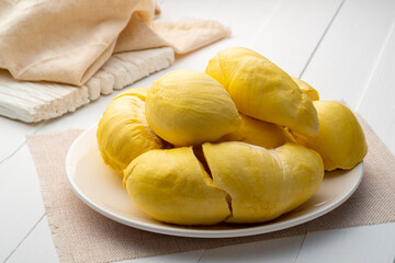 Peeled durian fruit.Thai yellow colour fruit on white plate ,southeast Asian called the King of...