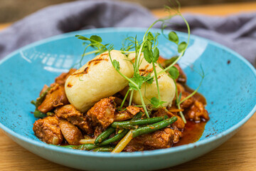 Hungarian goulash with a bread dumpling prepared on the grill. Close up