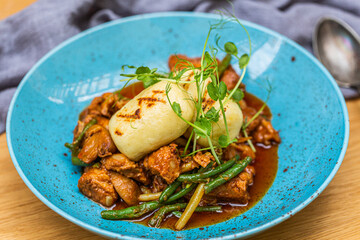 Hungarian goulash with a bread dumpling prepared on the grill. Close up