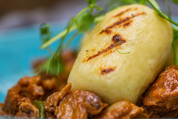 Hungarian goulash with a bread dumpling prepared on the grill. Close up