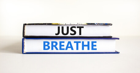 Just breathe and psychological symbol. Concept words Just breathe on beautiful books. Beautiful white table white background. Business psychological and Just breathe concept. Copy space