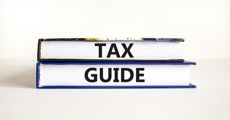 Tax guide symbol. Concept words Tax guide on beautiful books. Beautiful white table white background. Business and Tax guide concept. Copy space.