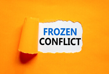 Frozen conflict symbol. Concept words Frozen conflict on beautiful white paper. Beautiful orange table orange background. Business and Frozen conflict concept. Copy space.