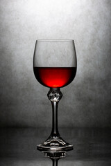 Still life with a glass of red liquid