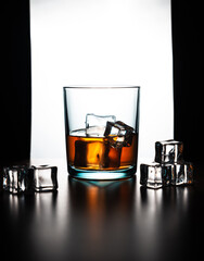 Front vertical view silhouette of a glass of whiskey and ice cubes