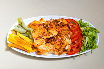 Turkish and Arabic Traditional Ramadan doner kebab with tasty tomato sauce and rice or turkish pilav in white plate on wood table background. ( Pilav ustu doner)