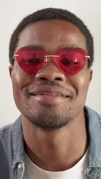 close up of an african man with heart shaped sunglasses