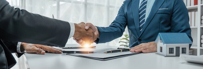 House model with agent and customer discussing for contract to buy, get insurance or loan real...