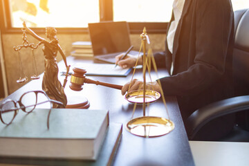 Brass court scales are used to decorate a table in a legal advisor office for aesthetic reasons ,Because the brass court scales are a symbol of justice. legal advisor concept.
