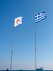 National flags of Cyprus and Greece fluttering in front of blue sky  