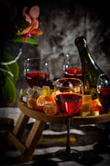 A glass of red wine in a low key on a blurred background