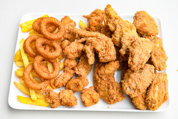 Fried Chicken breast hot crispy strips crunchy chicken tenders  isolated on white background.Nuggets isolated on white background on a plate