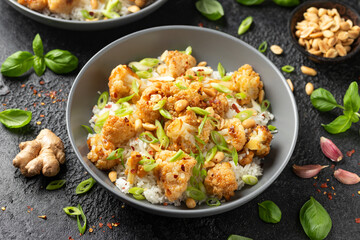 Kung Pao Cauliflower with rice, peanuts and spices. Healthy vegan food.