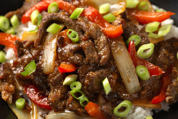 Stir fry Crispy Orange Beef with sweet peppers, onion and rice. Asian food
