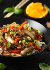 Stir fry Crispy Orange Beef with sweet peppers, onion and rice. Asian food