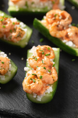 Cucumber Shrimp Sushi Boats with Spicy Mayo, Rice, Chives and sesame seeds