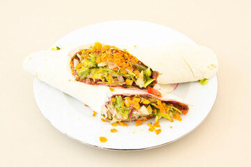 Cig kofte (raw meatball) with lettuce, tomato, pickle and lemon, hot Chee kofta. Turkish local raw food concept.Table scene of assorted take out or delivery foods. Doritoslu cig kofte durum.
