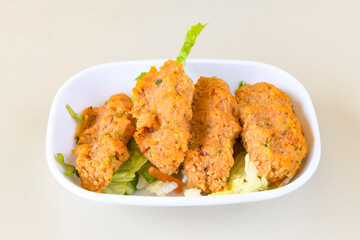 Fried Chicken breast hot crispy strips crunchy chicken tenders  isolated on white background.Nuggets isolated on white background on a plate