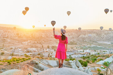Free carefree happy inspired girl traveler walking in valley in Anatolia, Kapadokya. Touching...
