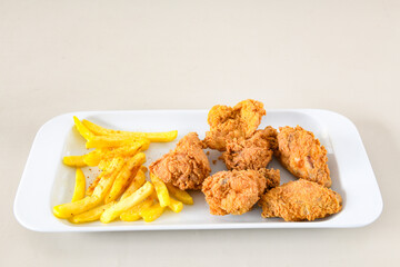 Fried Chicken breast hot crispy strips crunchy chicken tenders  isolated on white background.Nuggets isolated on white background on a plate