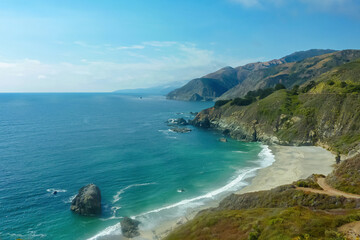 Panoramic view of deserted beach along the rugged coastline of Big Sur with Santa Lucia Mountains along famous Highway 1, Monterey county, California, USA, America. Road trip on summer day at seaside