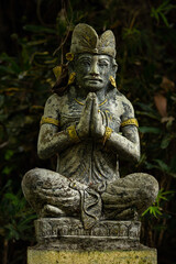 Fototapeta na wymiar Stone statue on a dark background. Bali. Indonesia