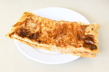 Turkish style meat stuffed filo dough borek served kol boregi. Cheese and minced pie are sliced on a marble background. Turkish name: Kol Boregi, ispanakli, kiymali, Su Boregi