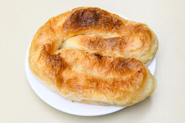 Turkish style meat stuffed filo dough borek served kol boregi. Cheese and minced pie are sliced on a marble background. Turkish name: Kol Boregi, ispanakli, kiymali, Su Boregi