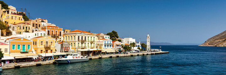 View of the beautiful greek island of Symi (Simi) with colourful houses and small boats. Greece, Symi island, view of the town of Symi (near Rhodes), Dodecanese.