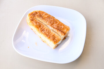 Turkish style meat stuffed filo dough borek served kol boregi. Cheese and minced pie are sliced on a marble background. Turkish name: Kol Boregi, ispanakli, kiymali, Su Boregi