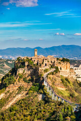 The famous Civita di Bagnoregio on a sunny day. Province of Viterbo, Lazio, Italy. Medieval town on the mountain, Civita di Bagnoregio, popular touristic stop at Tuscany, Italy.