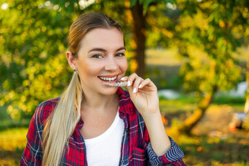 Happy young woman with invisible teeth aligner.