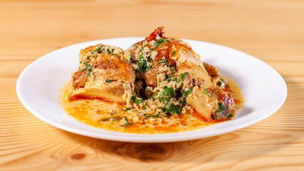 Shkmeruli is a traditional Georgian dish of chicken in garlic sauce in the white plate
