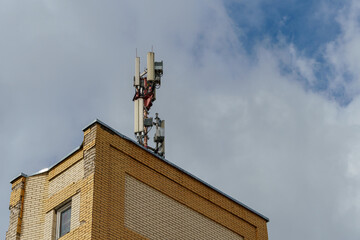 New GSM antennas on the roof of a residential building in the city for transmitting a 5g signal are a danger to human health. Radiation pollution of the environment through cell towers.