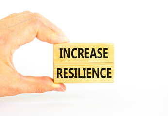 Increase resilience symbol. Concept word Increase resilience typed on wooden blocks. Beautiful white table white background. Businessman hand. Business and increase resilience concept. Copy space.