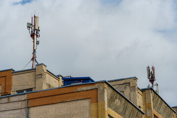 New GSM antennas on the roof of a residential building in the city for transmitting a 5g signal are a danger to human health. Radiation pollution of the environment through cell towers.