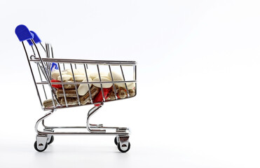 Shopping cart with medicines. Concept of health and pharmaceutical expenditure, medicine and health care. 