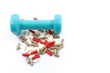 Pills or steroid tablets, or doping substances for athletes, next to gym dumbbells