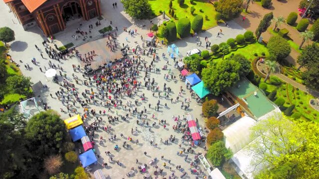 Top view of crowd of people in square. Mass gathering of people. Celebration of seafood in Georgia in Batumi. Lot of people came to square to celebrate fish festival. View from drone.