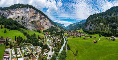 Lauterbrunnen valley with famous church and Staubbach waterfall. Lauterbrunnen village, Berner...