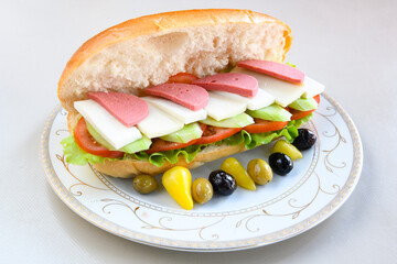 Close-up shot of Izmir's famous Turkish Traditional Kumru Sandwich, Çeşme Kumru , ingredients ready to eat salami, sucuk , tomato, cheddar cheese and fried cheese. Yengen eritme karisik sandvic.