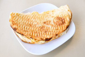 Turkish karisik atom Ayvalik tost ( kasarli bazlama tost) . Sucuklu, Kasarli, kavurmali karisik tost. Flat baked bread toasted