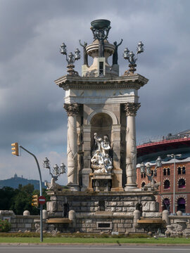 BARCELONA, SPAIN - SEPTEMBER 13, 2013:  The Central Fountain designed by Josep Maria Jujol in the Placa d'Espanya with the Arenas Centre in the background