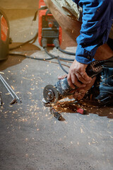 hands of worker working using grinder without protection or safety