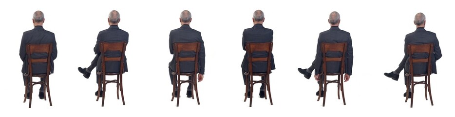 back view of a group of a same man sitting  on chair with suit on white background
