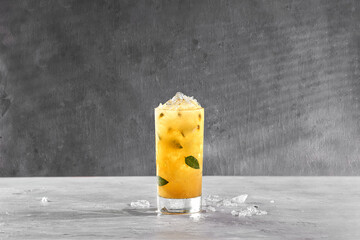 refreshing cocktail, passion fruit mojito with natural fruit on gray background
